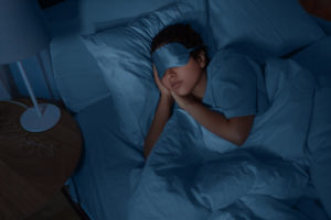 person sleeping with eye mask covering eyes