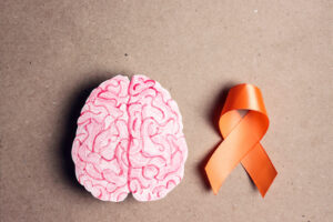 Multiple sclerosis ribbon next to drawing of brain