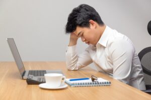 man with narcolepsy falling asleep while working
